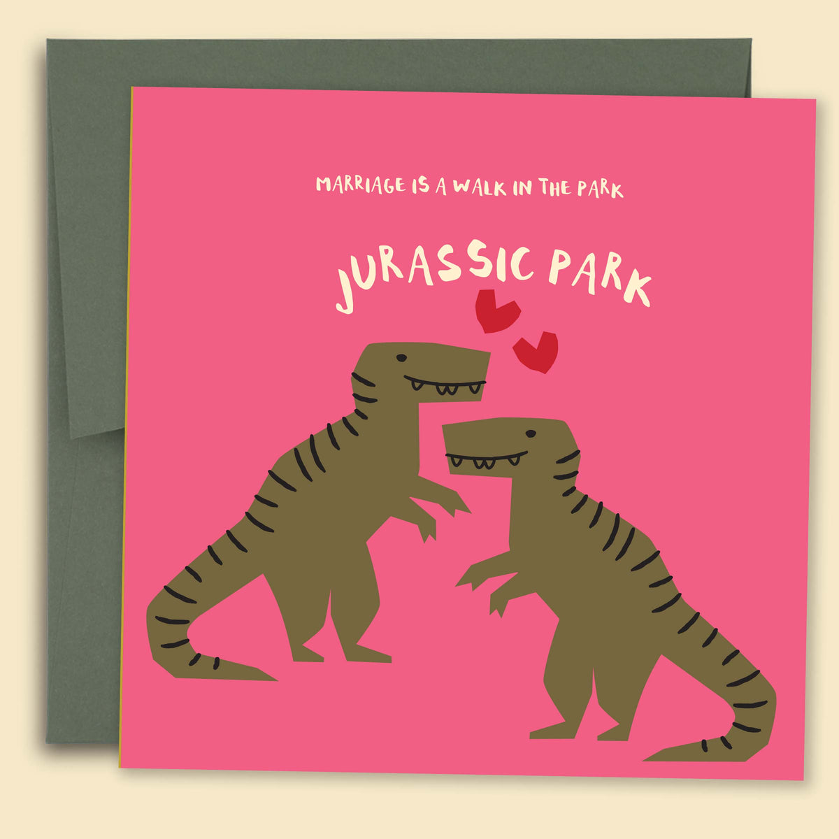 Greeting card with a playful illustration of two dinosaurs on a pink background, with the text 'MARRIAGE IS A WALK IN THE PARK' and 'JURASSIC PARK'. Australian-made greeting card by Papernest.