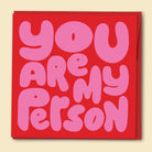 Red card with pink text 'YOU ARE MY PERSON' finished in holographic foil on a red background. Australian-made greeting card by Papernest