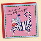 A colourful greeting card with an illustration by Constanza Goeppinger of of a person riding on the back of a striped cat, with the phrase 'And up to mischief they got!' written on it. Australian-made greeting card by Papernest.