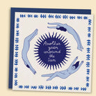 A greeting card with a hand-drawn illustration by Constanza Goeppinger of people floating arounda sun, surrounded by a blue border, with the text 'Another year around the Sun'. Australian-made greeting card by Papernest.