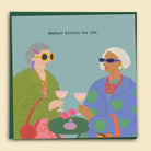 Illustrated by Constanza Goeppinger a greeting card featuring two older women drinkning a cocktail with the text 'Badass Besties For Life'. Australian-made greeting card by Papernest.
