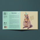 Greeting card with an illustration of a Quokka holding a cupcake and wearing a party hat . Front of the card reads, 
When everyone's singing, "Happy birthday" to you and you're just standing there like...