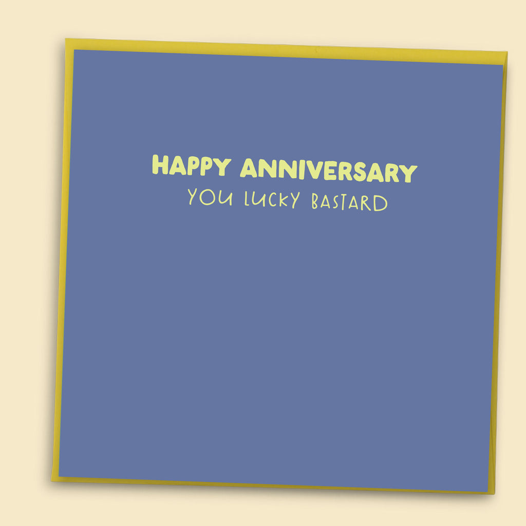 Funny anniversary card with blue background and yellow text reading Happy Anniversary You Lucky Bastard with yellow envelope