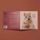 Greeting Card with a quokka illustration on a peach background. Greeting reads "You bring so much happiness to my life". Fun facts about the Quokka on the back of the card.