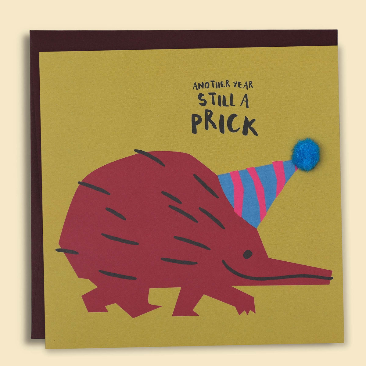 Greeting card with an illustration of a kiwi wearing a party hat and the text 'Another Year Still A Prick' on a yellow background. — Australian-made greeting card by Papernest