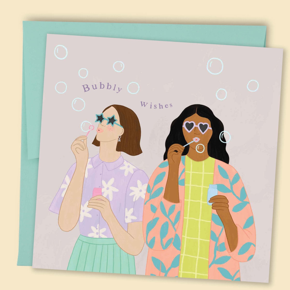 Illustrated by Constanza Goeppinger a greeting card featuring two women in fun outfits and sunglasses blowing bubbles with the text 'Bubbly Wishes'. Australian-made greeting card by Papernest