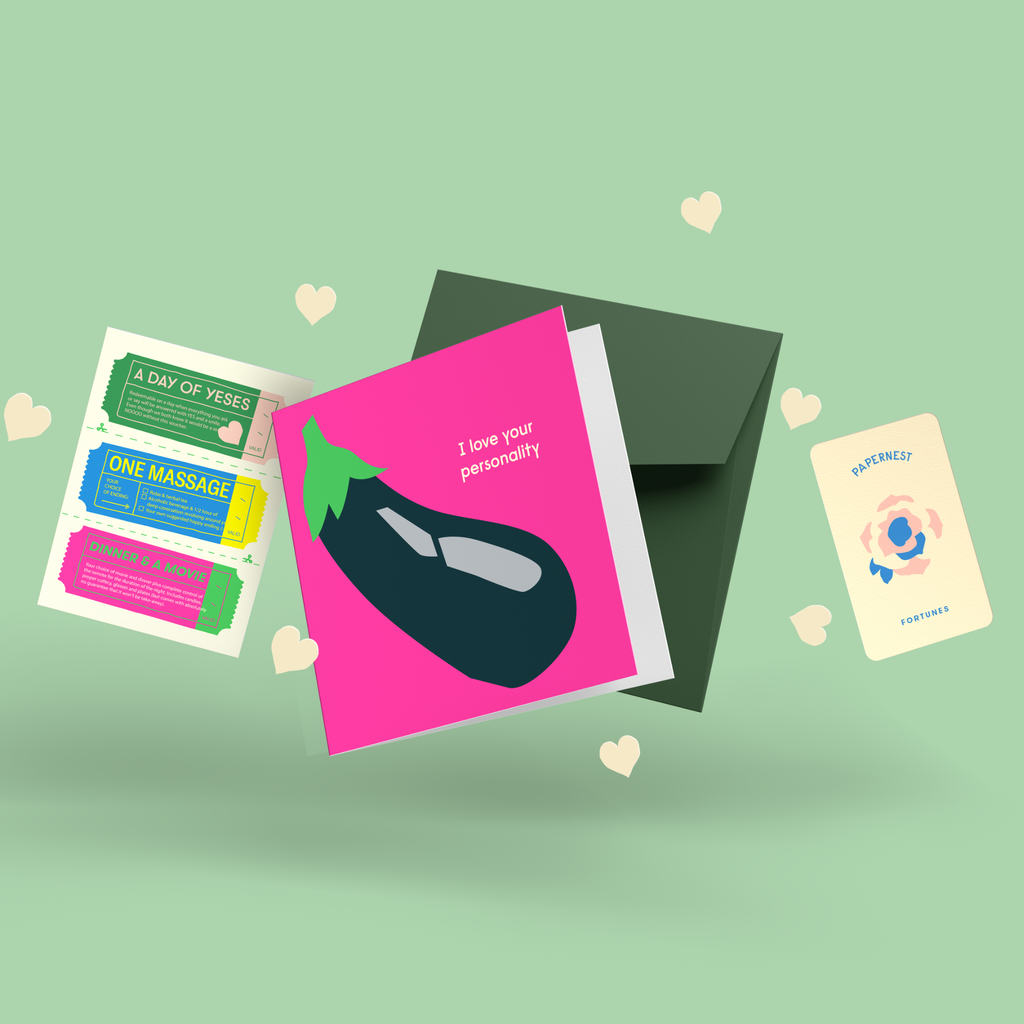Funny cheeky card with eggplant emoji illustration reading I Love Your Personality with pink envelope, love vouchers including One Massage and Dinner & A Movie, and Papernest novelty fortune card on green background
